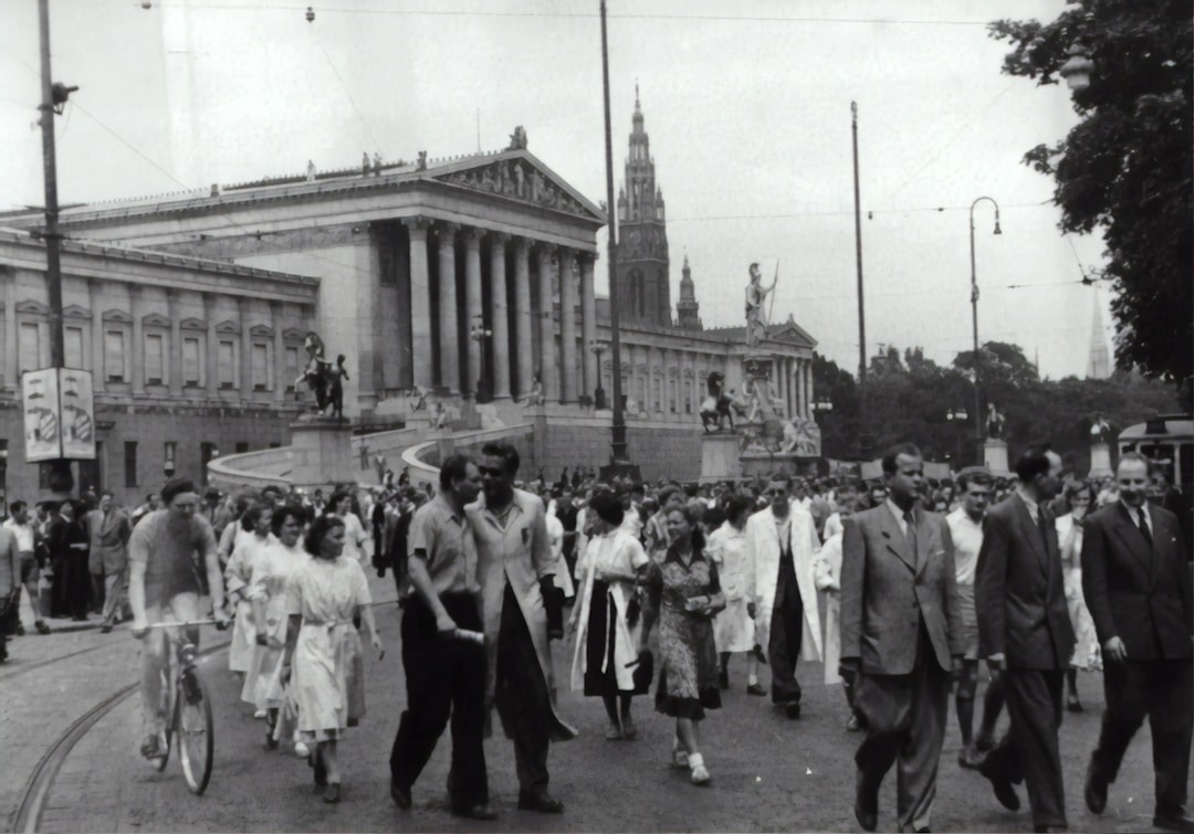 people walking on paved road, Student strike in Vienna. Demonstration train on the ring in front of the parliament. 1953