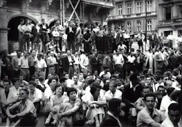 A group of community members gathered around a historic display at a local event.