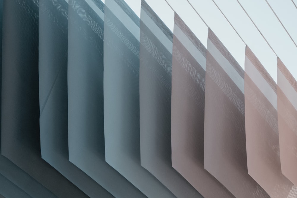 a close up of a row of blinds with a sky background