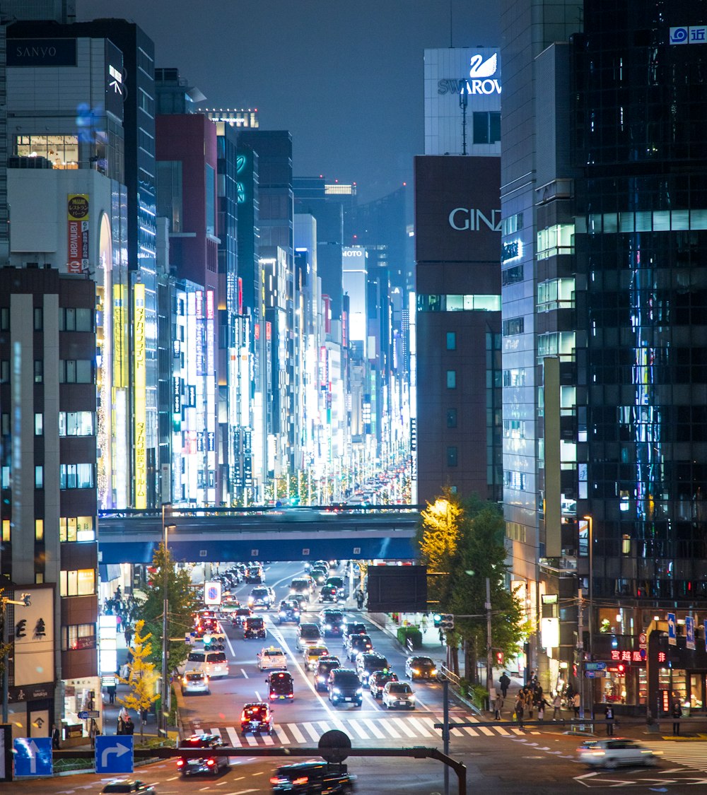 a city street filled with lots of traffic at night