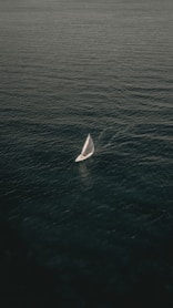 white sailing boat on body of water