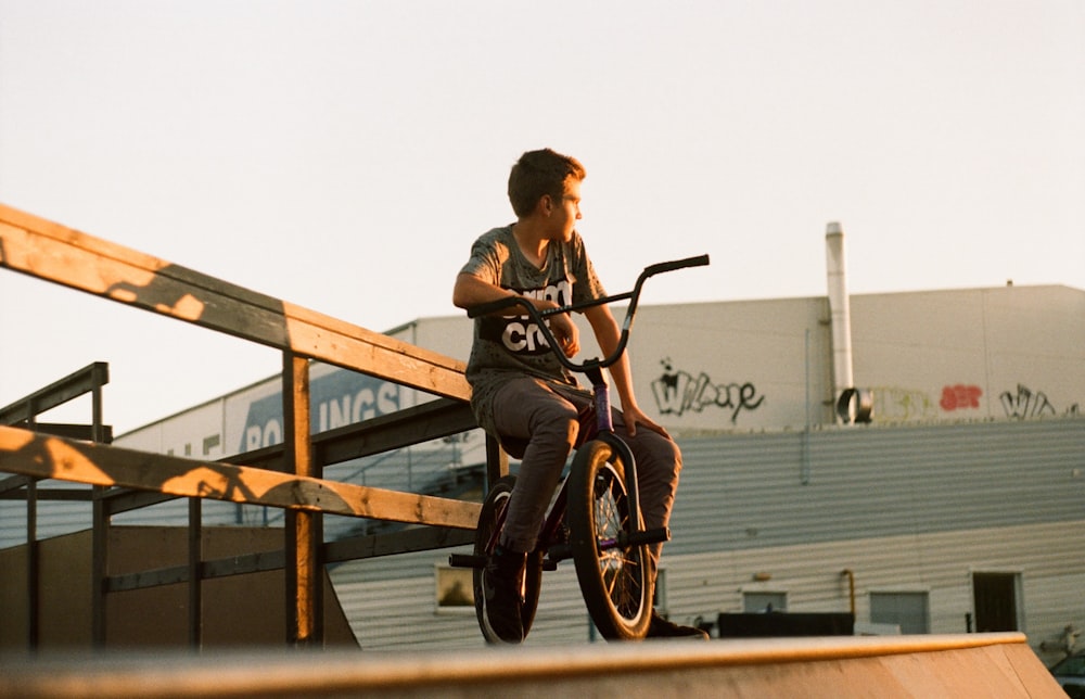 shallow focus photo of man riding BMX bike