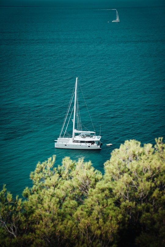 shallow focus photo of white boat on body of water in Ibiza Spain