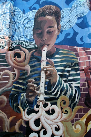 A vibrant mural depicting children dancing and playing instruments.