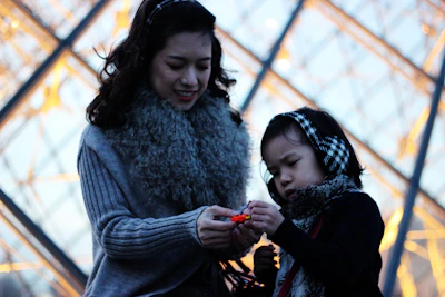 A smiling mother and child exploring a children’s museum exhibit.