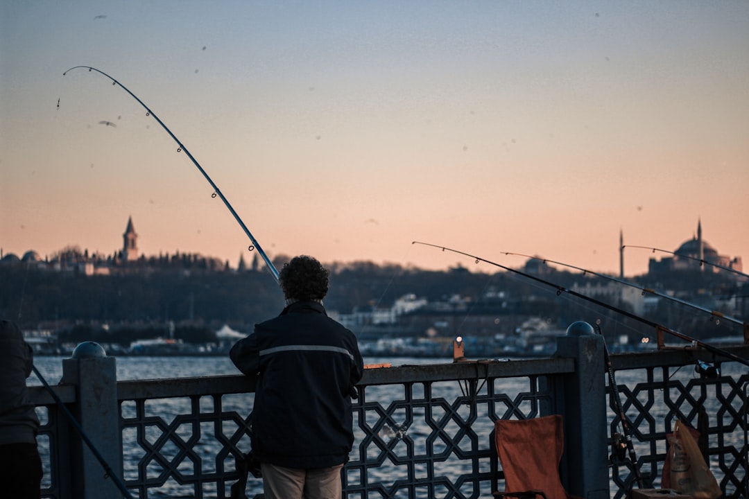 shallow focus photo of person fishing