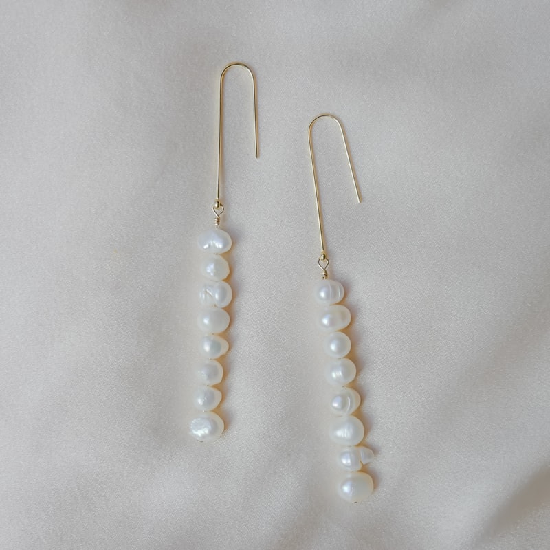 pair of white pearl earrings