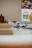 A cheerful kitchen countertop with vibrant vivanido utensils neatly arranged next to a bowl of fresh fruit.