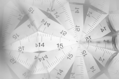 Round image of elegant wooden rulers on a black background