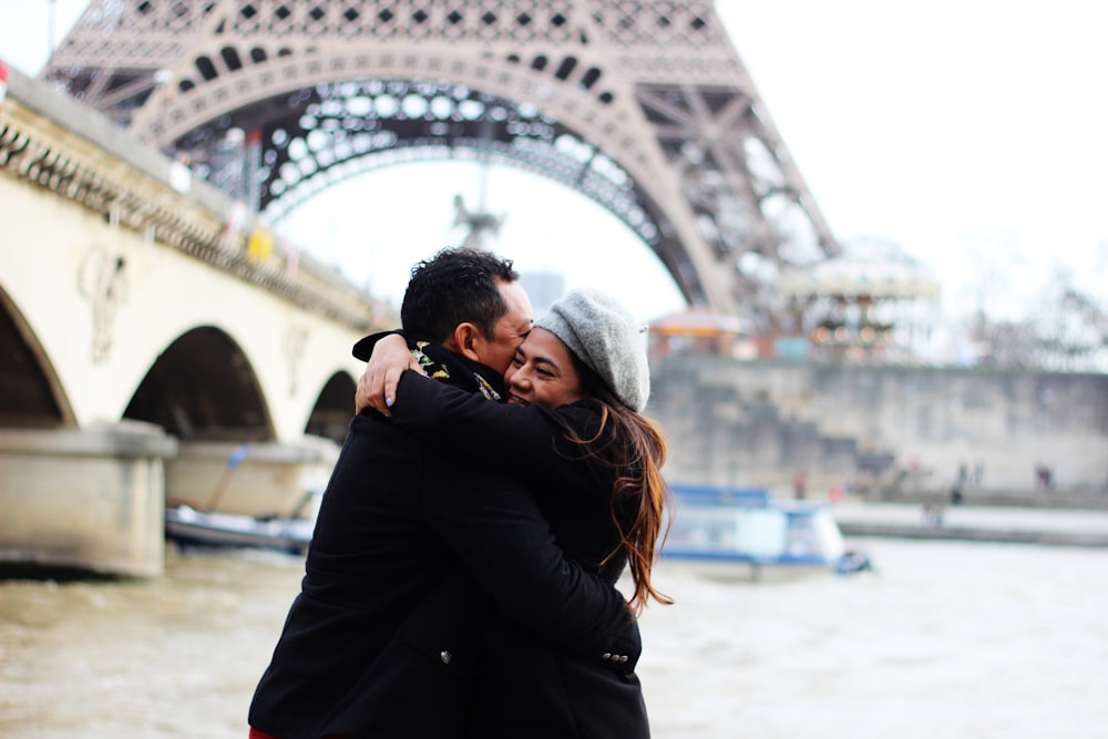 couple hugging near bridge