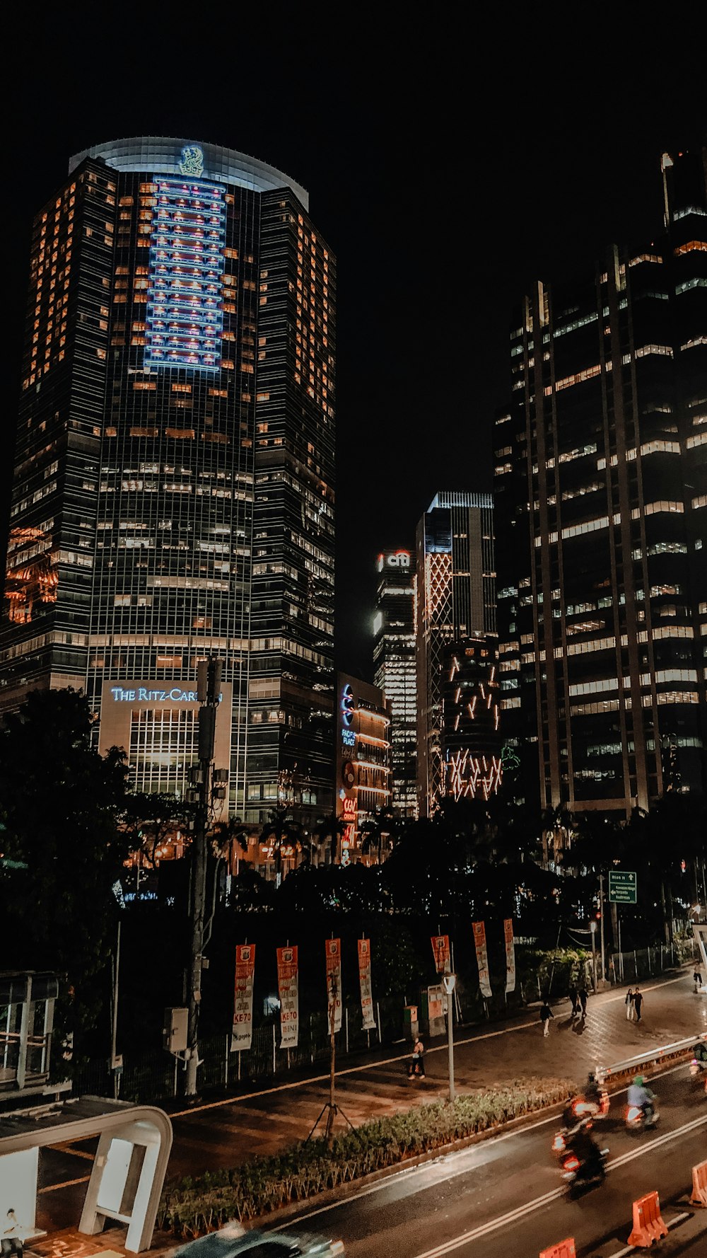 a city at night with a lot of tall buildings