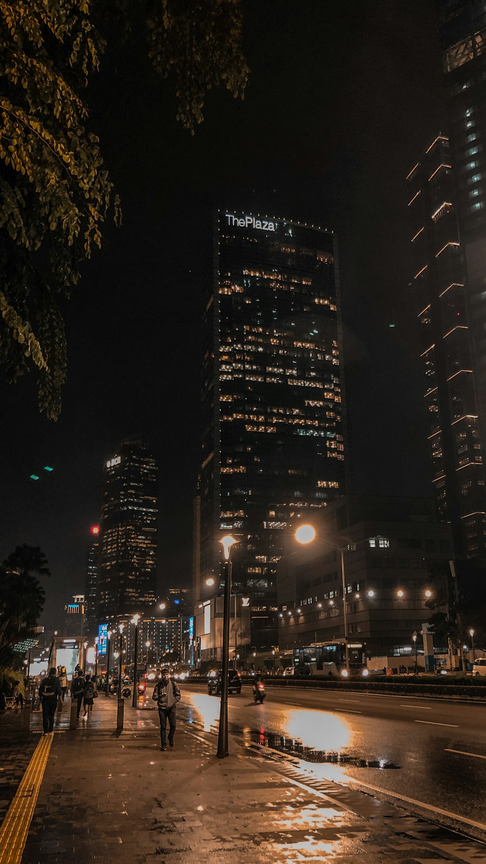 people walking on roadside at nighttime