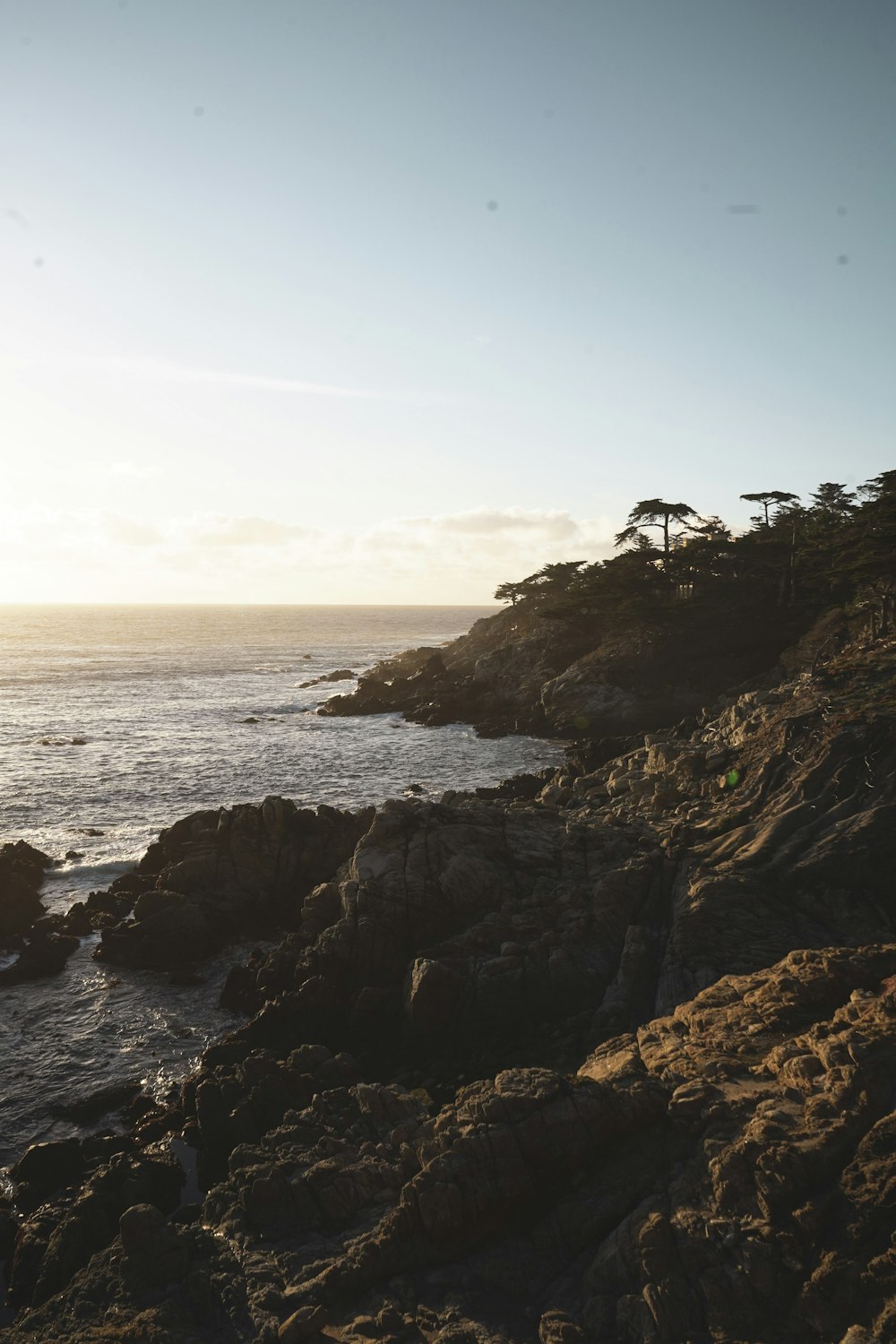 a view of the ocean from a rocky cliff