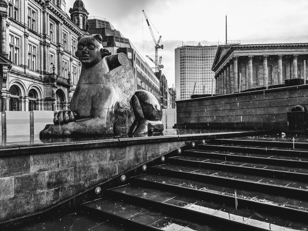 grayscale photography of sphinx statue and stairs