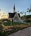 A serene sunrise over a quiet chapel, symbolizing hope and spiritual renewal.