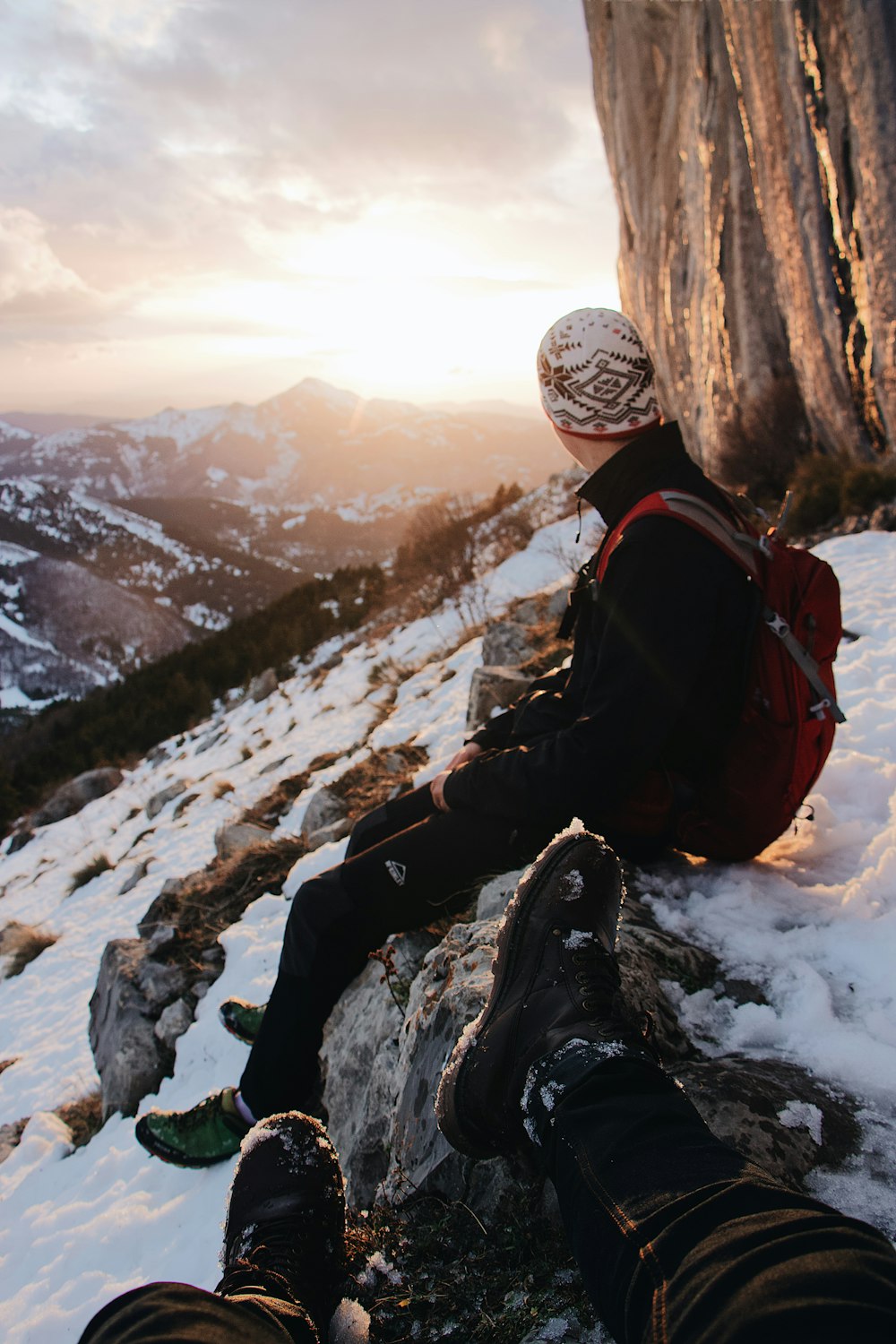 man sitting on rock