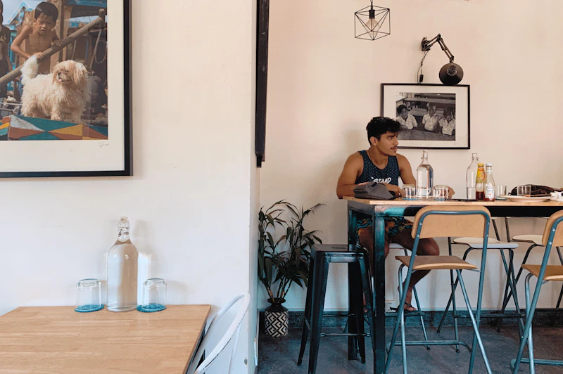 Man seated by dining table, relaxed at-home vibe
