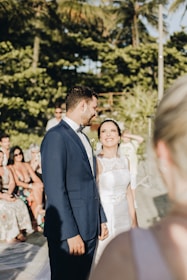 A picturesque outdoor setting with guests enjoying a destination wedding on a sunny beach.