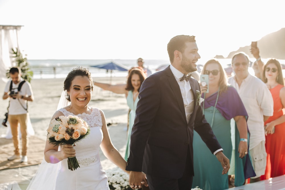 smiling man and woman in wedding dress and suit