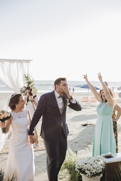 Bride and groom sharing a joyful moment on a sunlit beach in Sharm el Sheikh.