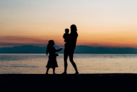 woman and children on beach shore