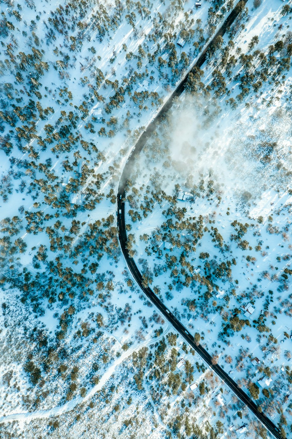 an aerial view of a snow covered field