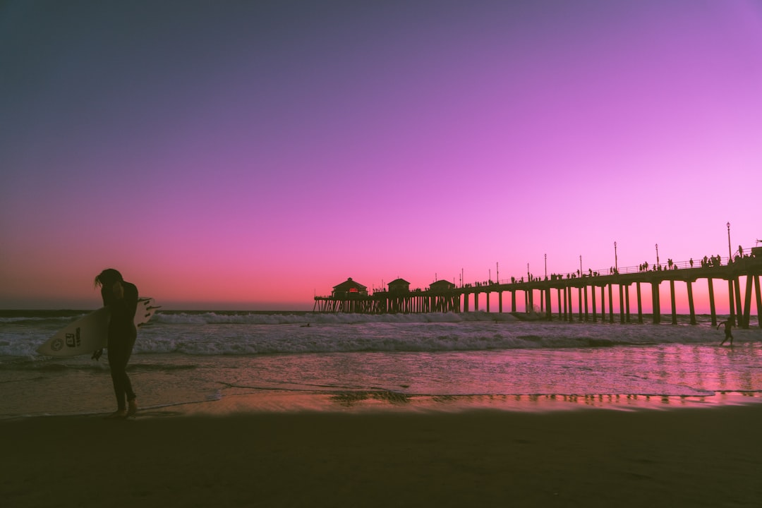 woman carying surfboard