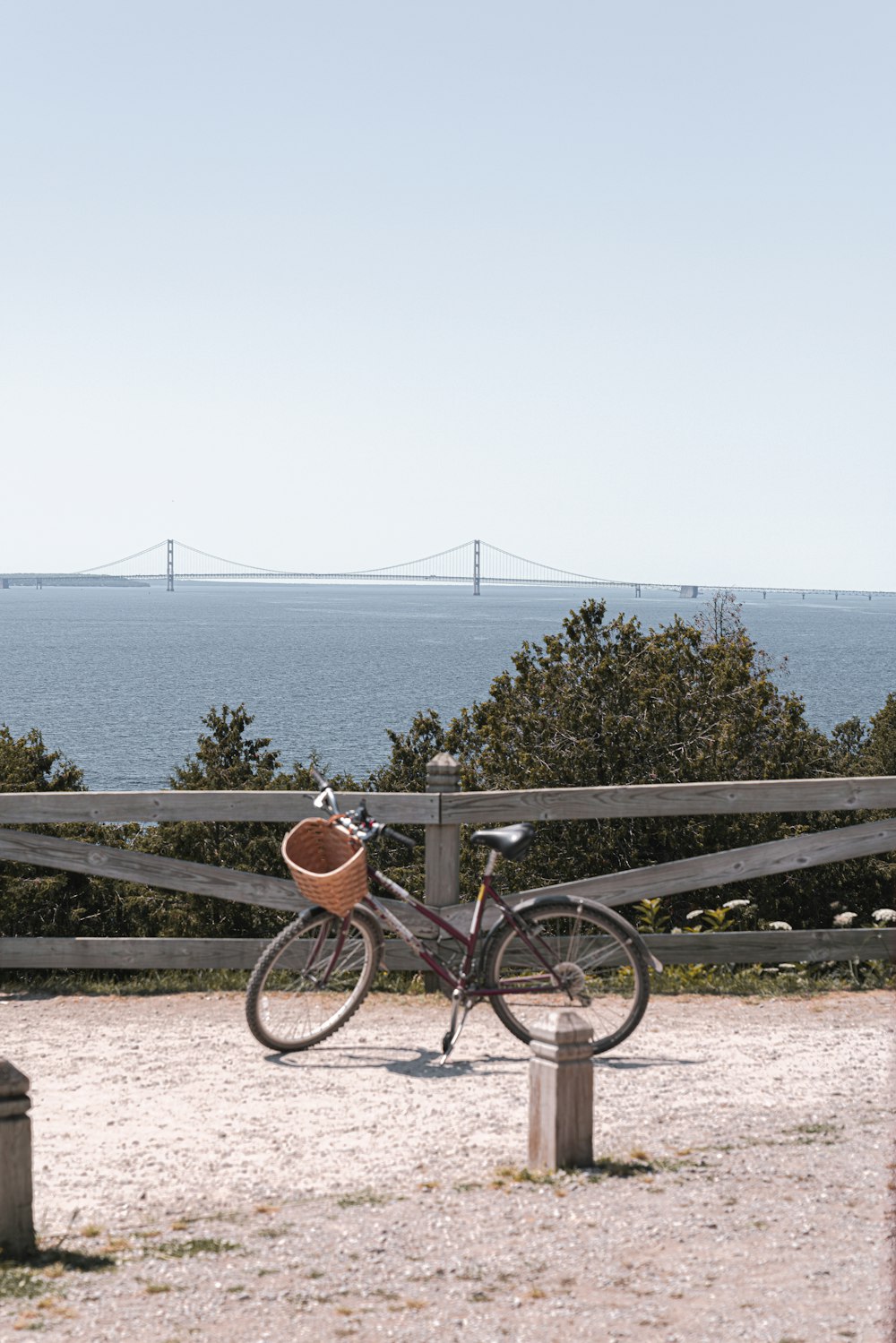 bike with basket parked near fence during day