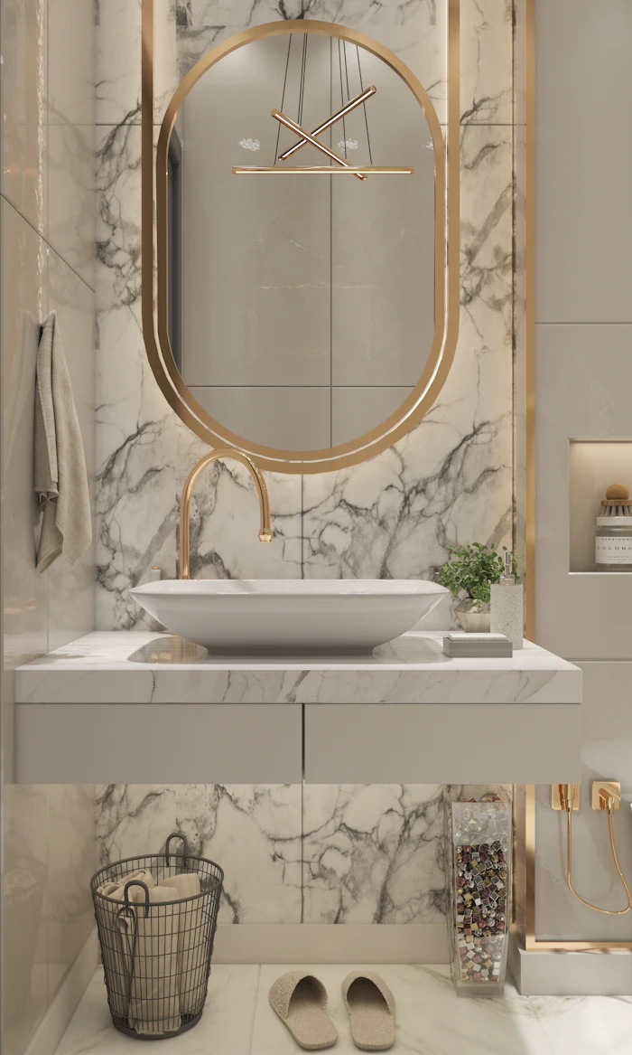 Marble bathroom with gold oval mirror and vessel basin