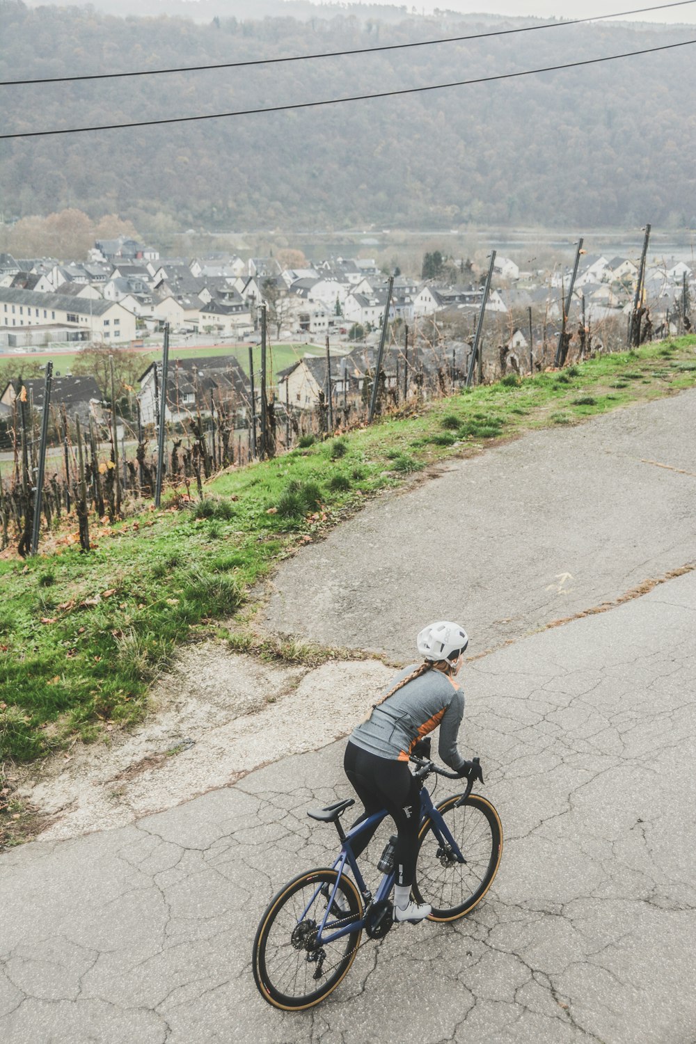 person in gray long-sleeved shirt riding bike