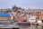 A scenic view of Prague featuring historic buildings and a river.