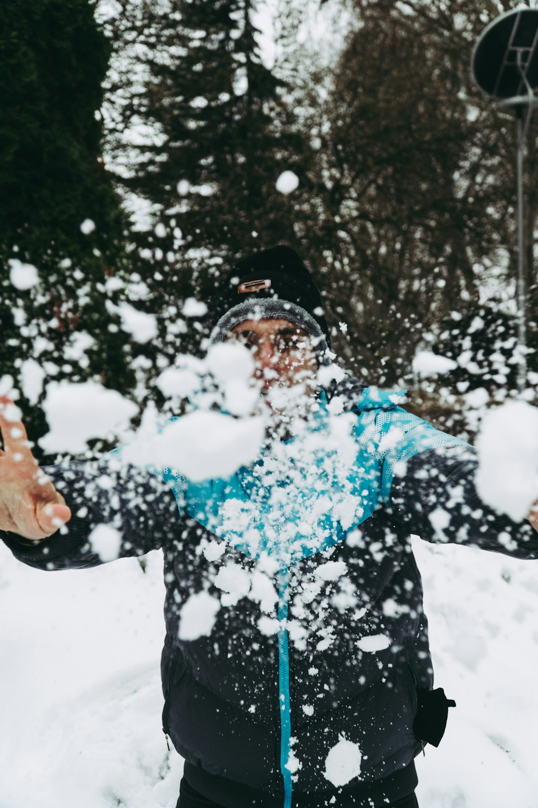 woman throwing white snow