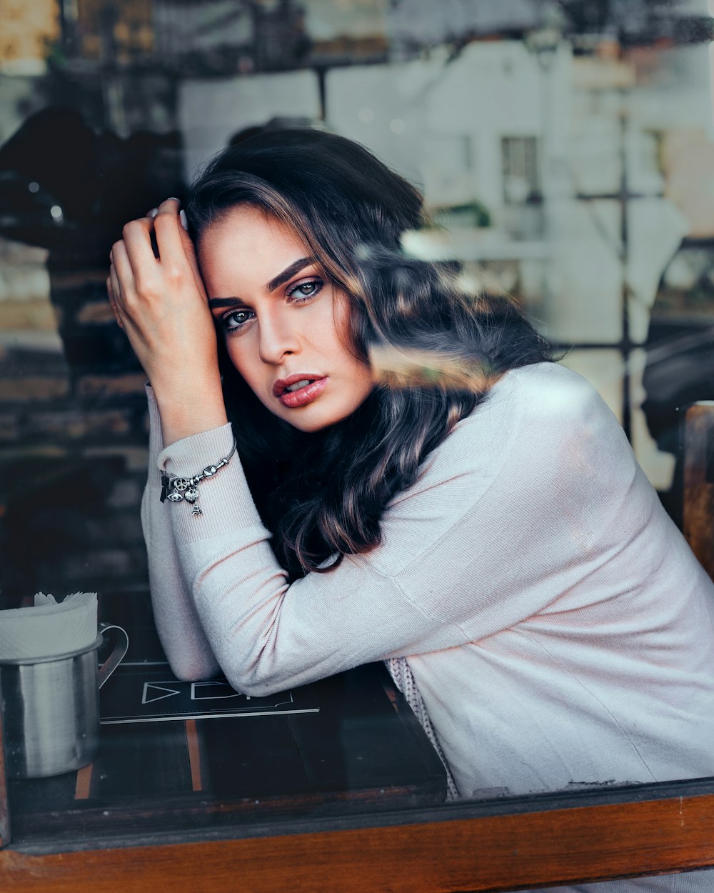 selective focus photography of woman leaning on table