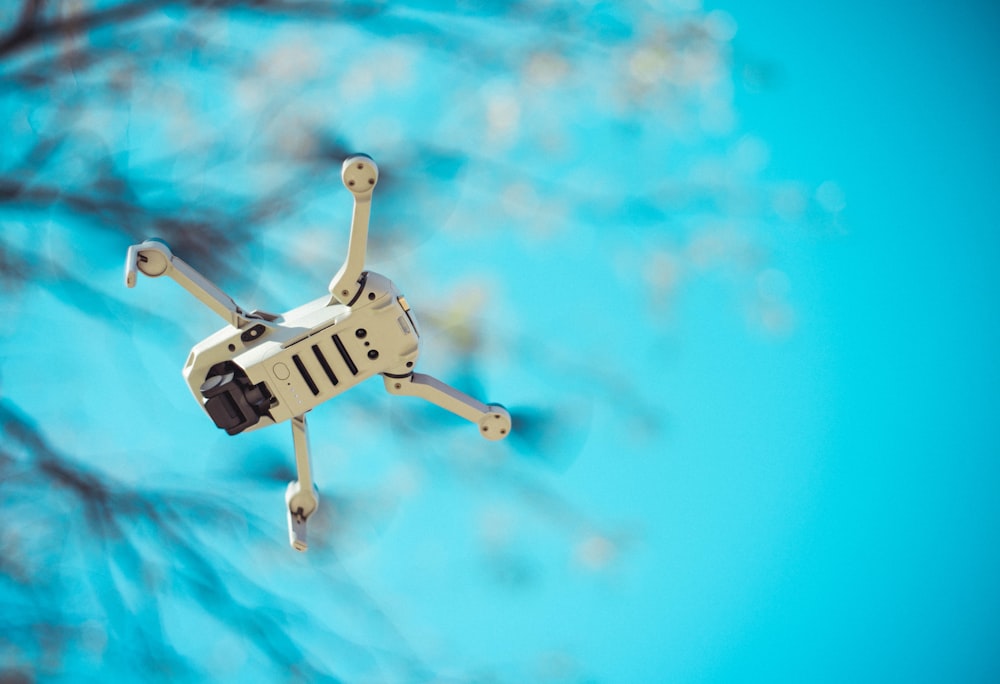 shallow focus photo of white quadcopter drone