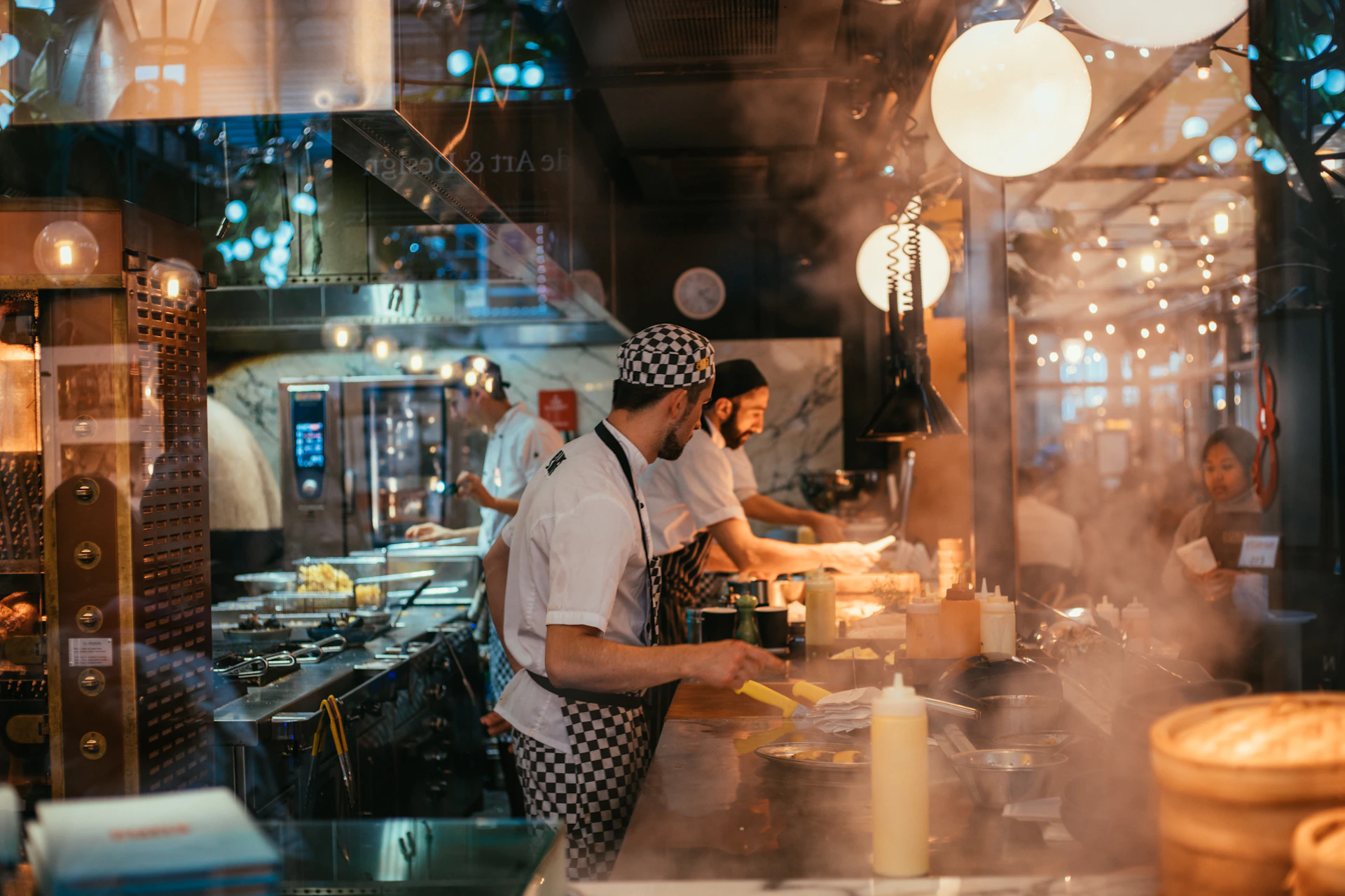 shallow focus photo of man wearing black and white apron