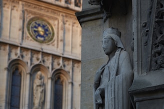 An elegant stone carving of the Solomon Grand Lodge emblem set against a backdrop of ancient columns.