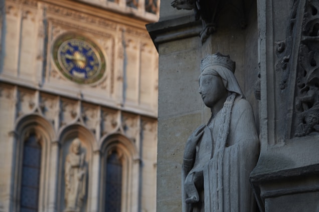 An elegant stone carving of the Solomon Grand Lodge emblem set against a backdrop of ancient columns.