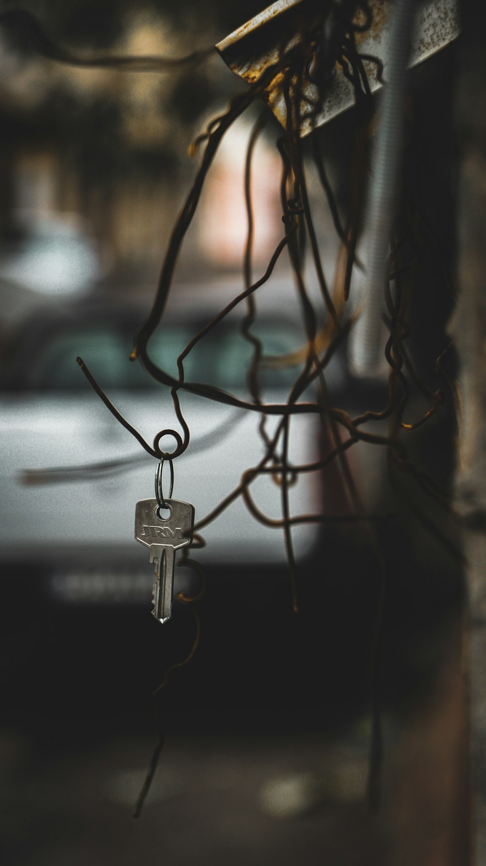 gray key hanging from wire