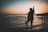 silhouette of woman standing near the fence