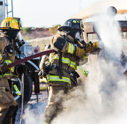 three fireman preventing fire during daytime