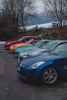 five assorted-color vehicles on road