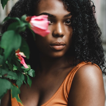 woman wearing orange scoop-neck blouse