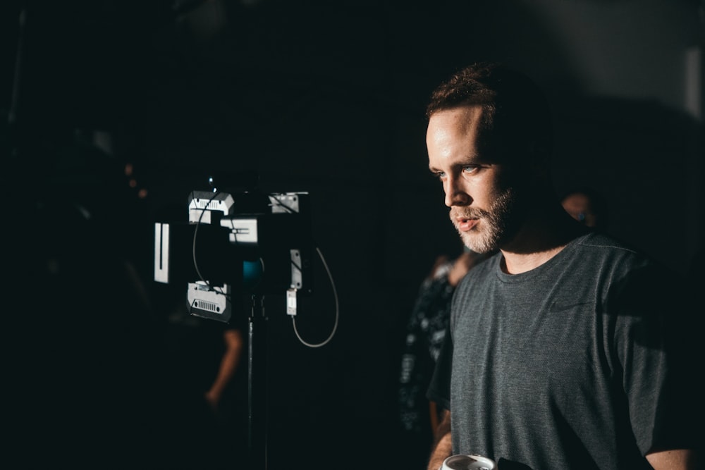 man standing near the video camera