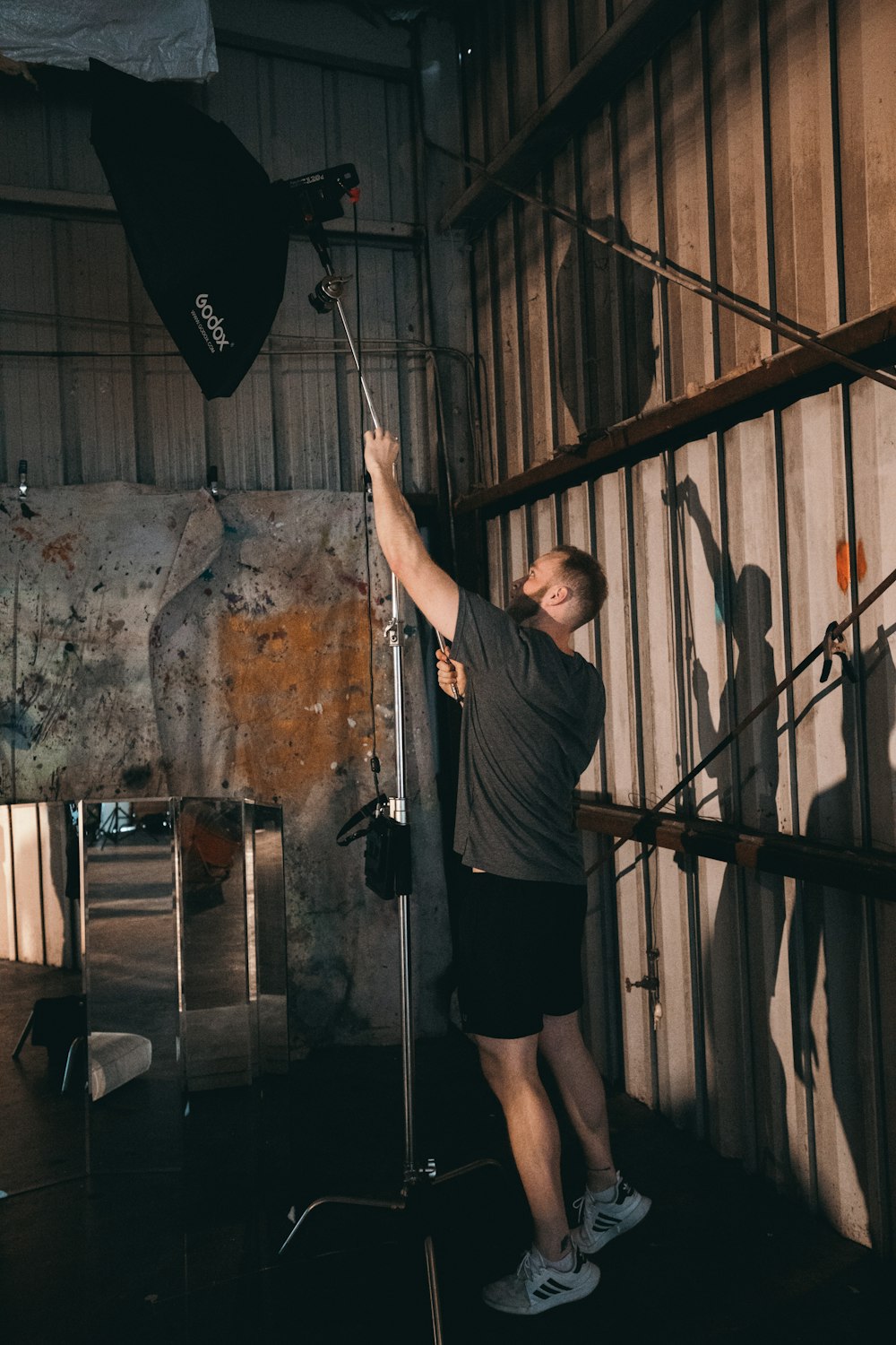 man fixing a studio lamp