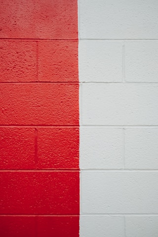 a red and white wall with a red and white stripe