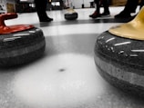Curling team sliding stones on an ice rink during a local competition