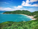 high-ground photography of sea and island during daytime