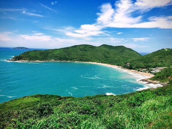 high-ground photography of sea and island during daytime