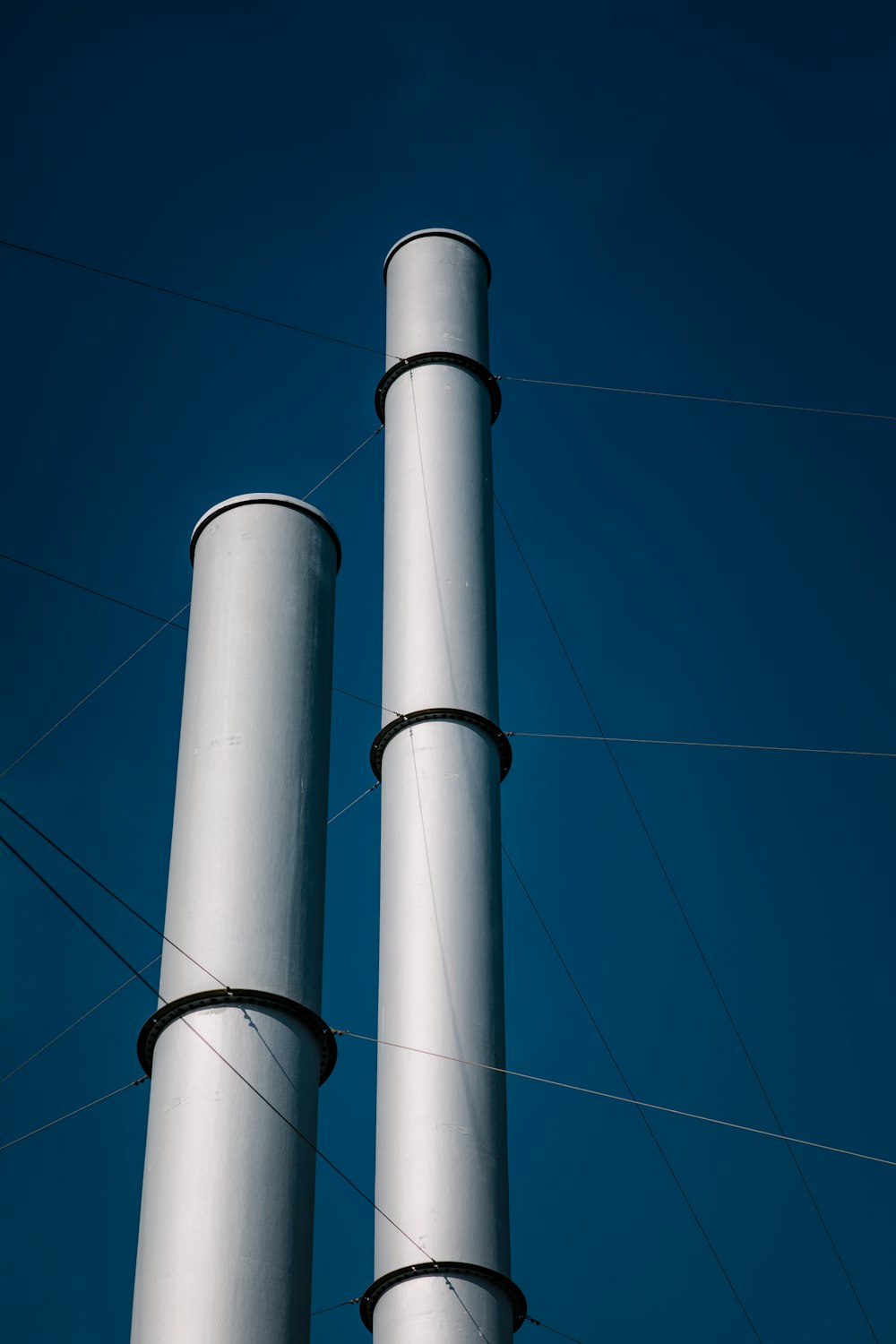 a couple of tall white poles sitting next to each other