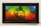 A colorful painting features a serene face within a circular cutout at the center of a vibrant background blending rainbow colors including red, green, blue, and yellow. The texture appears tactile with swirling patterns and abstract designs.